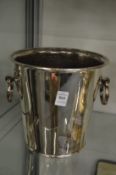A plated twin handled wine cooler.