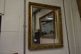 A gilt framed mirror.