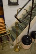 An adjustable brass floor standing lamp.