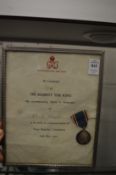 A 1937 Coronation medal with certificate, framed together with a 1953 Coronation tin.