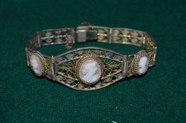 A filigree bracelet with cameo mounts.