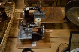 Two miniature sewing machines.