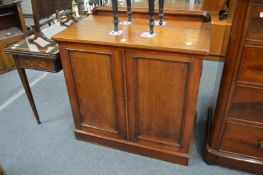 A 19th century mahogany cupboard with rising top.