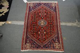 A small Persian style rug, 106cm x 67cm.