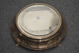 A plated mirrored circular cake stand.
