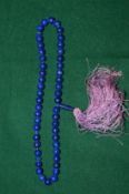 A lapis bead necklace.