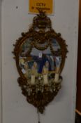 An ornate cast metal three branch girandole (mirror cracked).