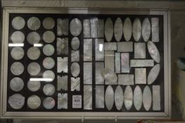 A collection of Chinese mother of pearl counters, some framed and glazed.