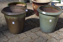 A near pair of glazed garden pots.