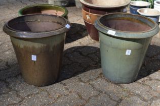 A near pair of glazed garden pots.