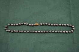 A bead necklace with silver clasp.