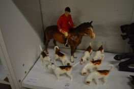 A Beswick hunting group to include a horse and huntsman and seven beagles (lacking fox).