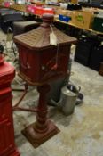 A large floor standing reproduction cast metal post box.