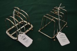 Two silver toast racks.