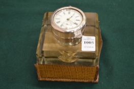 A good desk glass inkwell, the white metal hinged cover inset with a watch.