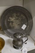 A small pewter lidded tankard or measure and an early pewter dish.