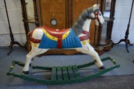 A painted carved wood rocking horse.
