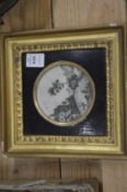 A circular silk work picture in an ebonised and gilded frame.