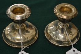 A pair of silver dwarf candlesticks.