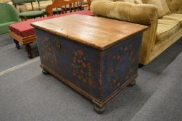 A Continental pine coffer with floral painted decoration.