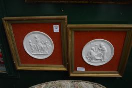 A pair of Copenhagen parian ware circular plaques, framed.