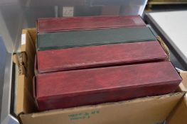 Two boxes containing twelve cigarette card albums.