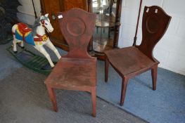 A pair of distressed painted shield back hall chairs.