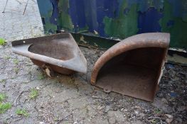 Two cast iron corner water troughs.