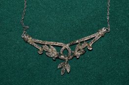 Decorative silver pendant and chain.