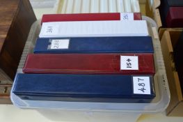 A box of five collector card albums.