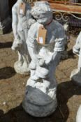 A painted reconstituted stone garden ornament of a young lady.