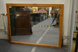 A large pine framed mirror.