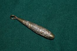 A silver pendant with engraved decoration.