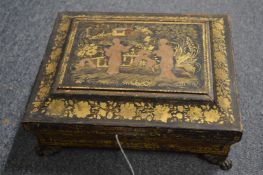 A Regency gilt decorated black Japanned sewing box (faults).