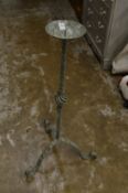 A wrought iron floor standing pricket style candlestick.