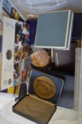 A box of collector coins and medallions.