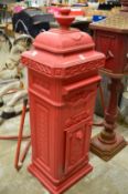 A large reproduction cast metal floor standing post box.