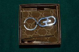 A Gucci key ring with original box and packaging.