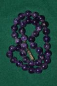 An amethyst bead necklace.