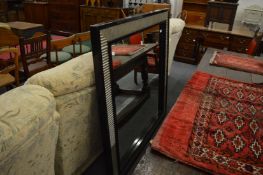 A large stylish square shaped wall mirror.