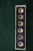 A cased set of six silver swan place name holders.