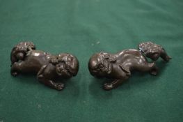 A pair of Chinese silver inlaid fo dogs, tails detached.