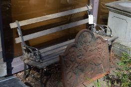 A garden bench with cast irons ends and wooden slats.