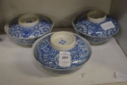 A set of three Chinese blue and white bowls and covers.