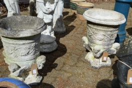 A pair of reconstituted stone garden urns of classical form.