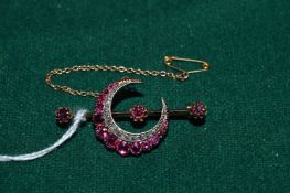 A good gold and gem set crescent shaped brooch.