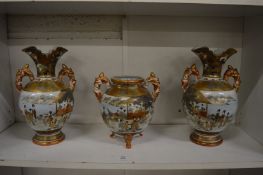 An early 20th century satsuma garniture comprising, pair of twin handled vases and a twin handled