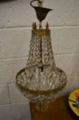 AN ORMOLU AND CUT GLASS CHANDELIER.