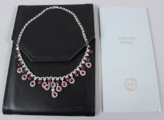 A GOOD WHITE METAL, DIAMOND AND RUBY NECKLACE, stamped 750, the diamond set necklace set with pear