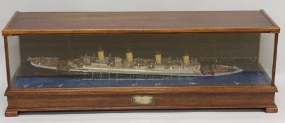 A SUPERB HANDMADE MODEL OF THE SINKING TITANIC in a glass and wooden show case. Entitled THE LOSS OF